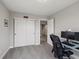 Office area showcasing a glass desktop, rolling chair, and nearby closet at 14823 W 70Th Dr # A, Arvada, CO 80007