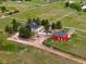 Expansive acreage with lovely green home and red barn surrounded by white fencing at 41504 Vista Ridge, Parker, CO 80138