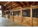 Image showcasing the wooden horse stalls inside the barn at 41504 Vista Ridge, Parker, CO 80138