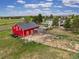 Rustic red barn offers classic charm, a spacious interior, and secure animal pens, making it ideal for equestrian or agricultural pursuits at 41504 Vista Ridge, Parker, CO 80138