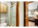 Bathroom with wood-framed shower and toilet, featuring a door to the main bedroom at 41504 Vista Ridge, Parker, CO 80138
