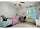 Bright bedroom with a ceiling fan, window, dresser, bed, and comfortable seating at 41504 Vista Ridge, Parker, CO 80138
