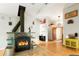Beautiful fireplace with a wood burning stove and tile surround on hardwood floors at 41504 Vista Ridge, Parker, CO 80138