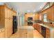 Stylish kitchen with wood cabinets, center island, and stainless steel appliances at 41504 Vista Ridge, Parker, CO 80138