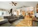 Open-concept living room flows into kitchen with vaulted ceilings and wood burning fireplace at 41504 Vista Ridge, Parker, CO 80138