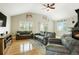 Cozy living room with wood floors, fireplace, vaulted ceilings, and lots of natural light at 41504 Vista Ridge, Parker, CO 80138
