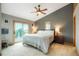 Spacious main bedroom with a ceiling fan, closet, balcony access, and a bedside table at 41504 Vista Ridge, Parker, CO 80138