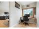 Cozy office with a wooden desk, monitor, chair, window view, and hardwood floors at 41504 Vista Ridge, Parker, CO 80138