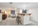 Basement with bar area, stools, couch and entertainment center at 6880 E Appleton Cir, Centennial, CO 80112