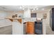 Basement bar area featuring sink, mini fridge, and display shelving at 6880 E Appleton Cir, Centennial, CO 80112