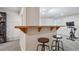 Basement bar area with stylish seating and exercise equipment in view at 6880 E Appleton Cir, Centennial, CO 80112