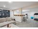 Spacious basement rec room with a bar, lounge area, and fitness equipment at 6880 E Appleton Cir, Centennial, CO 80112