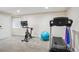 Finished basement offers a home gym area with treadmill, bike, and fitness accessories at 6880 E Appleton Cir, Centennial, CO 80112
