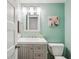 Bathroom with a white vanity, stylish light fixture, neutral wall paint, and toilet at 6880 E Appleton Cir, Centennial, CO 80112