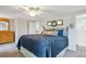 Bedroom features a ceiling fan, large bed, and view into the ensuite bathroom at 6880 E Appleton Cir, Centennial, CO 80112