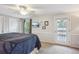 Bedroom with a ceiling fan, television, and door leading to a private balcony at 6880 E Appleton Cir, Centennial, CO 80112