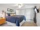 Bedroom features a ceiling fan, large bed, and closet at 6880 E Appleton Cir, Centennial, CO 80112