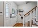 Foyer features a decorative door, staircase, hardwood floors, and decor on the wall at 6880 E Appleton Cir, Centennial, CO 80112