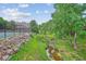 Scenic view of tennis court, creek, and common area at 6880 E Appleton Cir, Centennial, CO 80112
