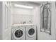 A closet-style laundry room features a washer, dryer, overhead rack and mounted ironing board at 6880 E Appleton Cir, Centennial, CO 80112