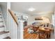 Bright living room with hardwood floors, a brick fireplace, large TV, and a cozy seating area at 6880 E Appleton Cir, Centennial, CO 80112
