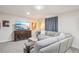Comfortable living room featuring a large sofa and entertainment center at 6880 E Appleton Cir, Centennial, CO 80112