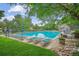 Large community pool with lounge chairs and verdant landscaping at 6880 E Appleton Cir, Centennial, CO 80112
