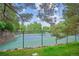 Outdoor tennis court surrounded by lush greenery at 6880 E Appleton Cir, Centennial, CO 80112