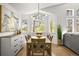 Dining room featuring hardwood floors, modern lighting, and views of the surrounding greenery at 1896 S Marshall Cir, Lakewood, CO 80232