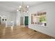 Bright foyer featuring hardwood floors, modern lighting, and a view of the outdoor patio at 1896 S Marshall Cir, Lakewood, CO 80232