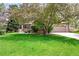 Charming home with a well-manicured lawn, mature trees, and a welcoming front entrance at 1896 S Marshall Cir, Lakewood, CO 80232