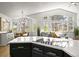 Open-concept kitchen featuring black cabinets, quartz counters, and stainless steel appliances with an eat-in kitchen in the background at 1896 S Marshall Cir, Lakewood, CO 80232