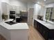 Modern kitchen featuring stainless steel appliances, white cabinets, and white marble countertops at 1896 S Marshall Cir, Lakewood, CO 80232
