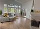 Bright living room with vaulted ceilings, large windows, hardwood floors and a cozy fireplace at 1896 S Marshall Cir, Lakewood, CO 80232