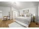 Bright bedroom featuring hardwood floors, a modern ceiling fan, and a plush white rug beneath a queen-size bed at 1896 S Marshall Cir, Lakewood, CO 80232