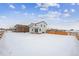 Spacious backyard with a snowy landscape and a two-story house at 4487 Boone Cir, Brighton, CO 80601