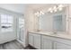 Elegant bathroom with double vanity, large mirror, and a shower at 4487 Boone Cir, Brighton, CO 80601