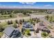 Stunning aerial view of a neighborhood with houses, solar panels, and well-maintained lawns on a sunny day at 26004 E Elmhurst Pl, Aurora, CO 80016