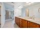 Bright bathroom with a standalone shower, double sink vanity, and decorative hardware and lighting at 26004 E Elmhurst Pl, Aurora, CO 80016