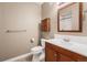 Cozy bathroom featuring a vanity with wood cabinets, a toilet, and a shower with tile surround at 26004 E Elmhurst Pl, Aurora, CO 80016