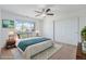 Bedroom featuring neutral carpet, ceiling fan and large window at 26004 E Elmhurst Pl, Aurora, CO 80016