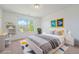 Bright bedroom with a large window, contemporary decor, and a comfortable bed with stylish accents at 26004 E Elmhurst Pl, Aurora, CO 80016