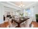 Elegant dining room featuring a modern chandelier, large window, and hardwood floors at 26004 E Elmhurst Pl, Aurora, CO 80016