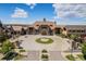 An eye-level shot of a grand building with a circular driveway, porte cochere, and stone accents at 26004 E Elmhurst Pl, Aurora, CO 80016