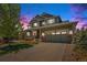 Charming two-story home with well-maintained landscaping, inviting porch, and two car garage at 26004 E Elmhurst Pl, Aurora, CO 80016