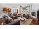 Inviting living room features a cozy fireplace, and an open layout to the kitchen and dining area at 26004 E Elmhurst Pl, Aurora, CO 80016