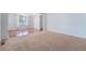 Open living space featuring neutral carpet and adjacent room with hardwood flooring at 26004 E Elmhurst Pl, Aurora, CO 80016