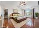 Spacious and bright main bedroom with hardwood floors, a ceiling fan, and a view of the outdoors at 26004 E Elmhurst Pl, Aurora, CO 80016