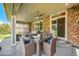 Covered patio area with stone columns, ceiling fans, and stylish seating, perfect for outdoor relaxation and entertaining at 26004 E Elmhurst Pl, Aurora, CO 80016