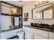 A well-lit bathroom with a shower-tub combo and modern fixtures at 100 Park W Ave # 1606, Denver, CO 80205